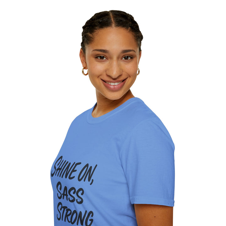 Person wearing a blue Shine On, Sass Strong, t-shirt, side view