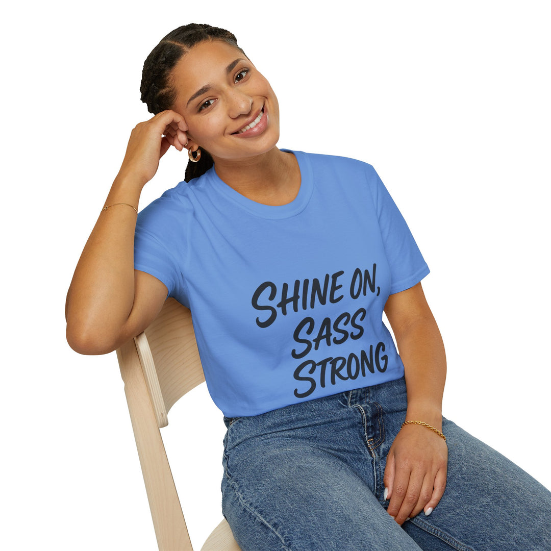 Female model wearing a blue t-shirt with 'Shine On, Sass Strong' text, sitting on a chair