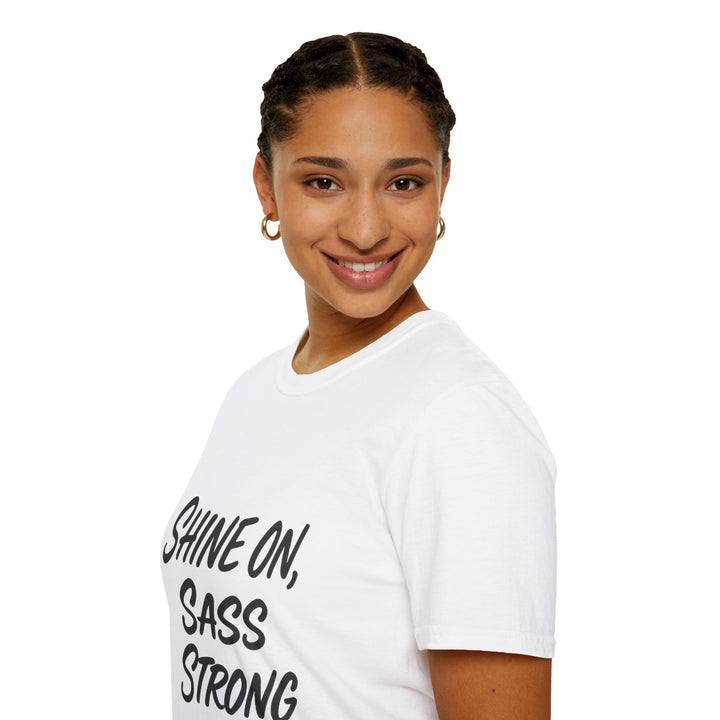 Female model wearing a white t-shirt with 'Shine on, Sass Strong' text, side view