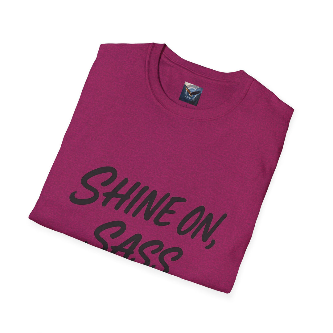 Folded magenta t-shirt with 'SHINE ON, CASS' text 