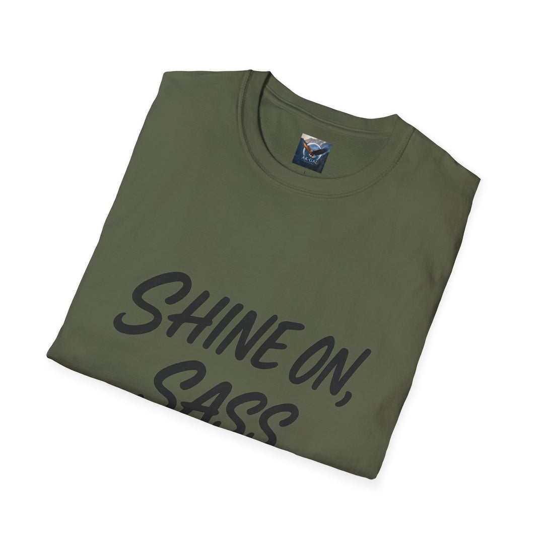 Folded green t-shirt with 'SHINE ON, SASS' text 