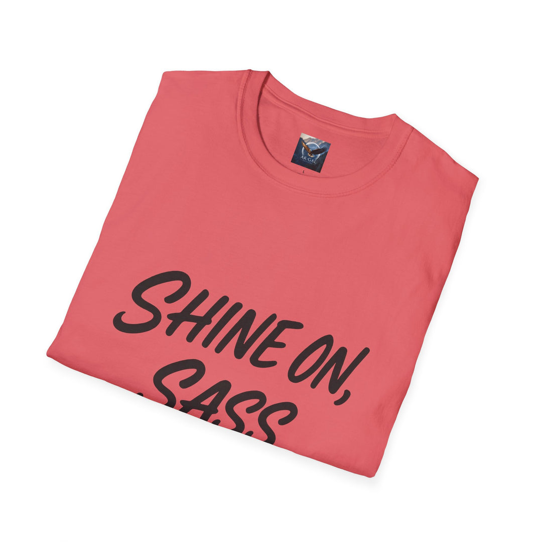 Folded pink t-shirt with 'SHINE ON, SASS' text 