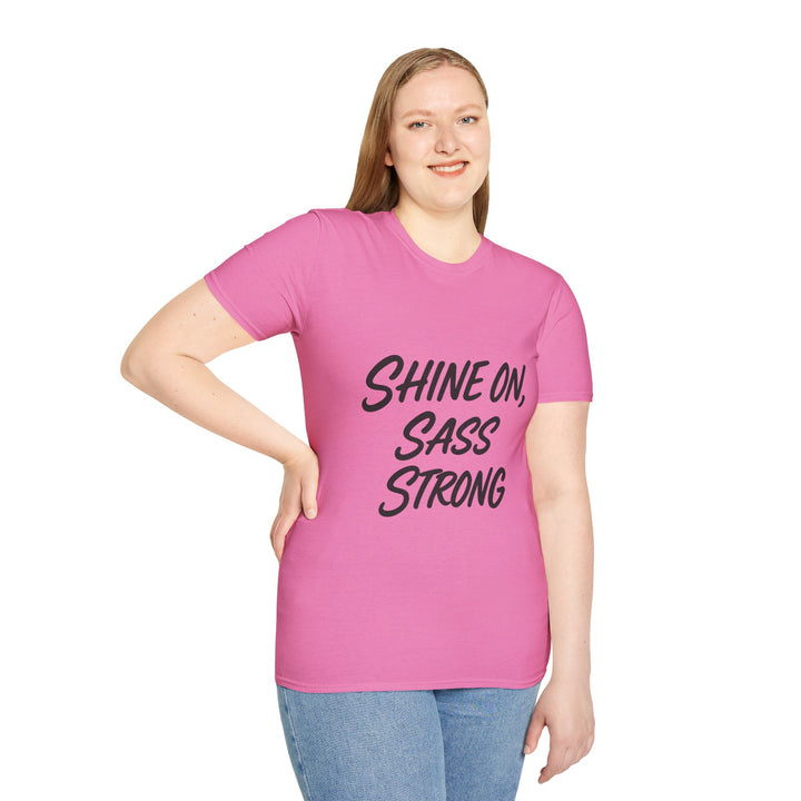 Model wearing a pink t-shirt with 'Shine On, Sass Strong' text 