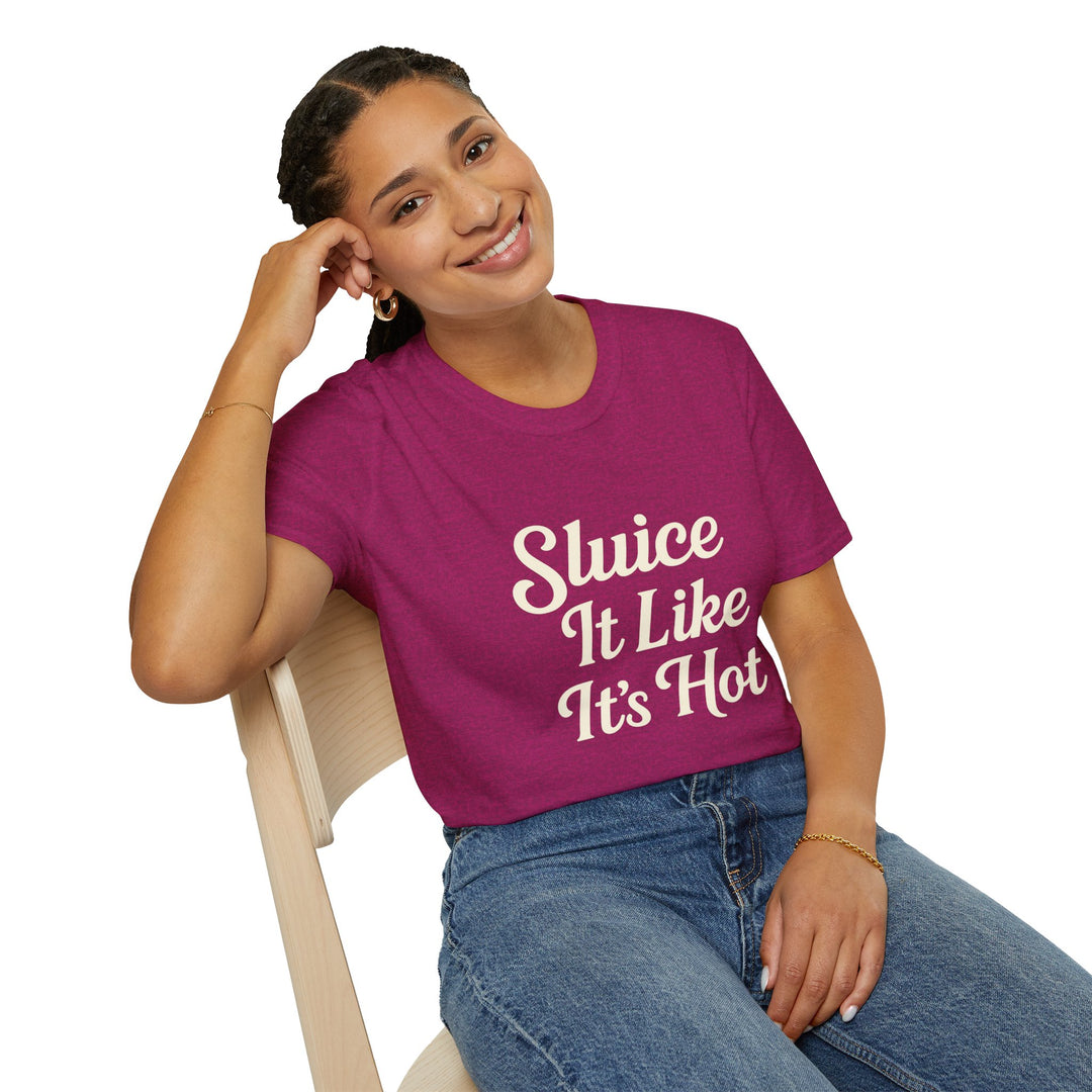 Person wearing a purple t-shirt with text Sluice It Like It’s Hot, sitting on a chair