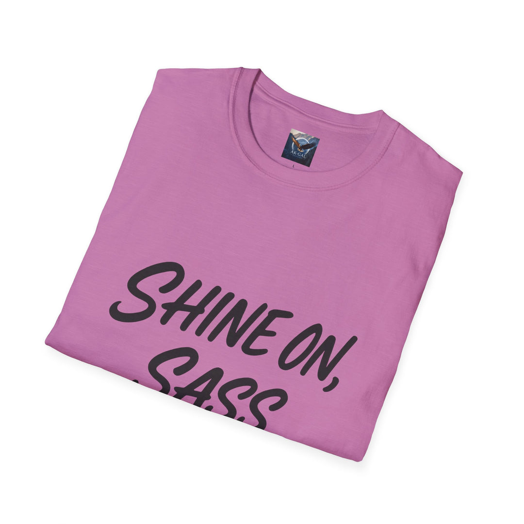 Folded pink t-shirt with 'SHINE ON, SASS' text 