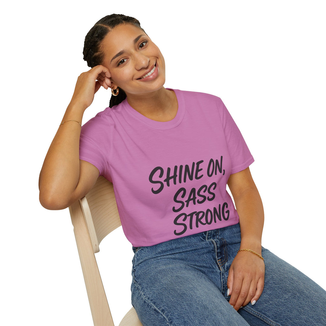 Female model wearing a pink t-shirt with 'Shine on, Sass Strong' text.